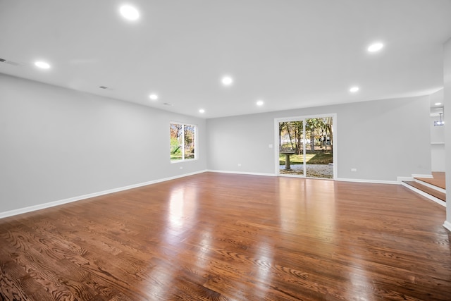 unfurnished living room with wood-type flooring