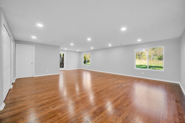 unfurnished living room featuring hardwood / wood-style floors and a wealth of natural light