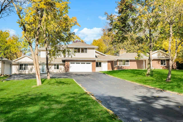 view of front of house with a front yard and a garage