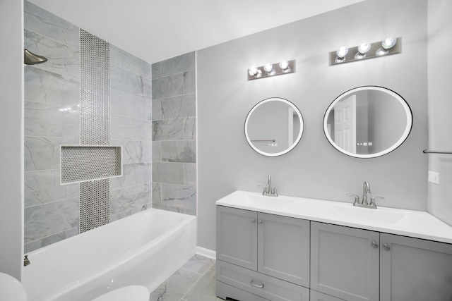 bathroom with tiled shower / bath and vanity