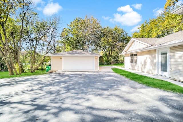 view of property exterior with an outdoor structure and a garage