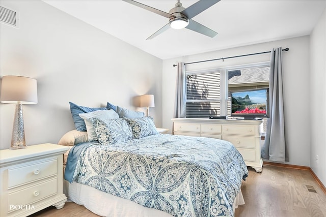 bedroom with ceiling fan and light hardwood / wood-style flooring