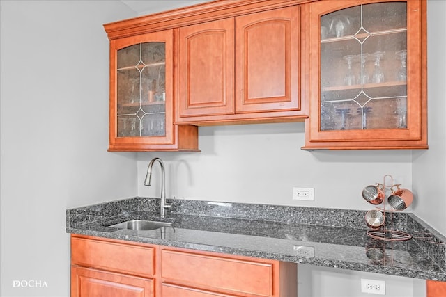 kitchen featuring sink and dark stone counters