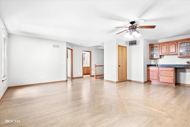 interior space featuring ceiling fan, sink, and light parquet floors