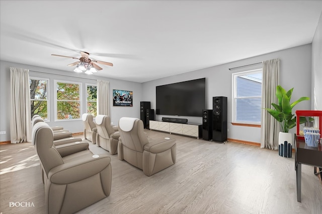 living room featuring light hardwood / wood-style floors and ceiling fan