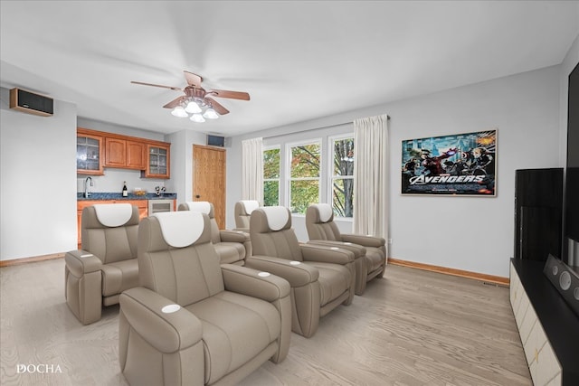 living room with light hardwood / wood-style floors and ceiling fan