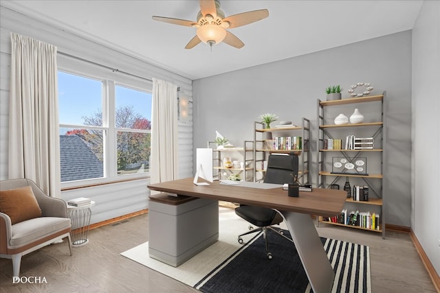 office space featuring light hardwood / wood-style floors and ceiling fan