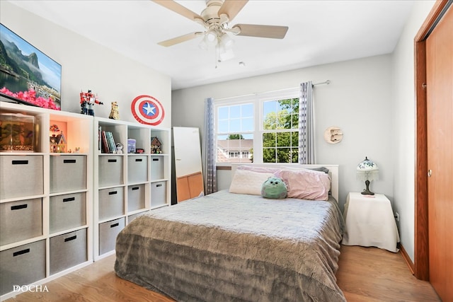 bedroom with light hardwood / wood-style floors and ceiling fan