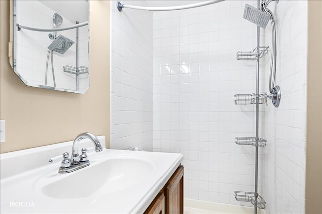 bathroom featuring vanity and tiled shower