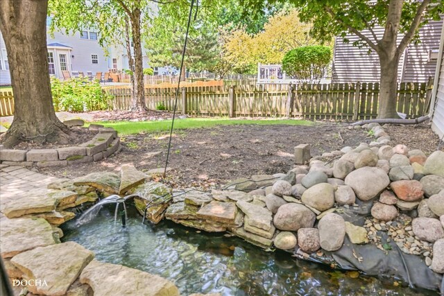 exterior space with a garden pond