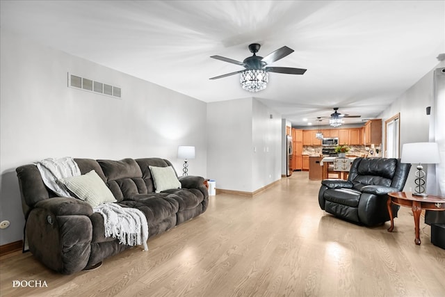 living room featuring light wood-type flooring and ceiling fan