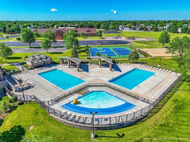 view of swimming pool featuring a patio and a lawn