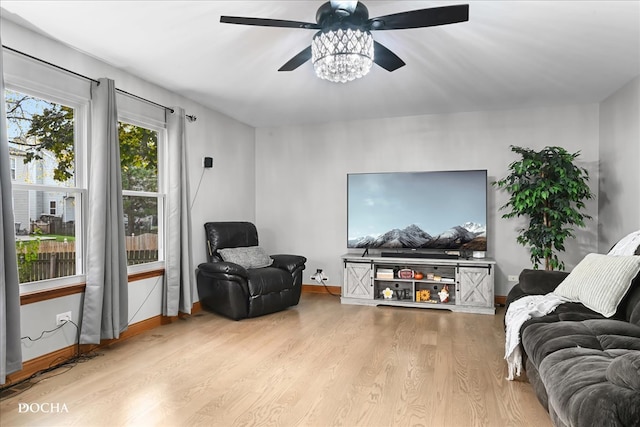 living area with ceiling fan and light wood-type flooring