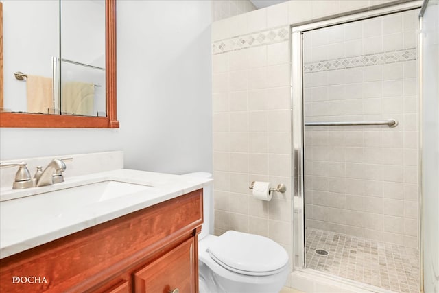 bathroom featuring vanity, toilet, and walk in shower