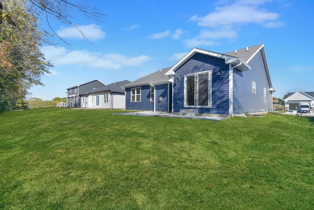 back of house with a patio area and a lawn