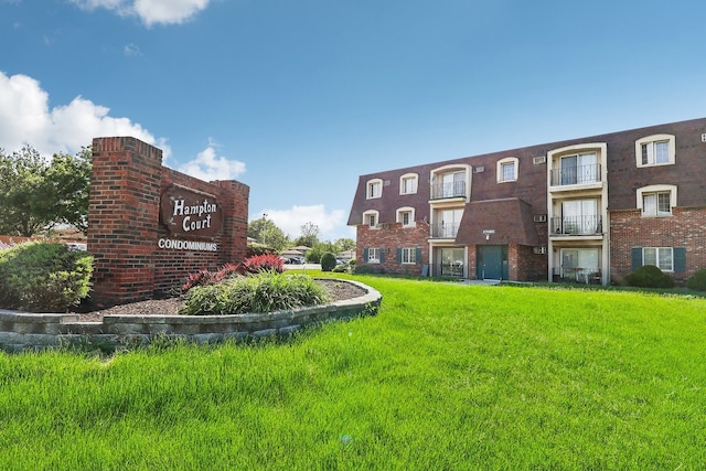 view of property's community with a lawn