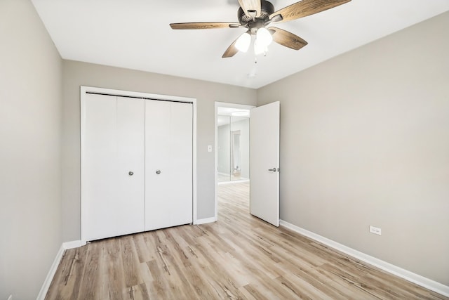 unfurnished bedroom with light hardwood / wood-style flooring, a closet, and ceiling fan