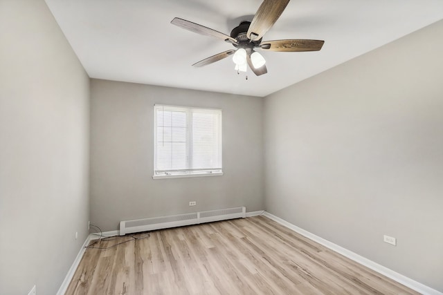 unfurnished room featuring a baseboard radiator, light hardwood / wood-style flooring, and ceiling fan