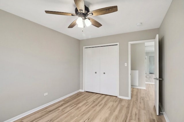 unfurnished bedroom with a closet, ceiling fan, and light hardwood / wood-style flooring