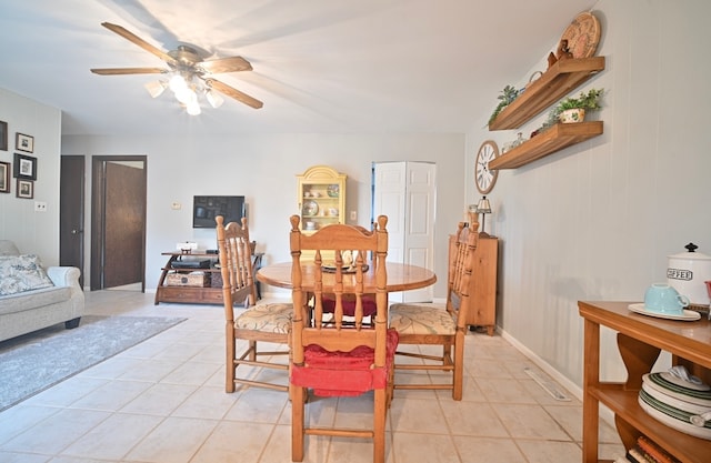 tiled dining area with ceiling fan