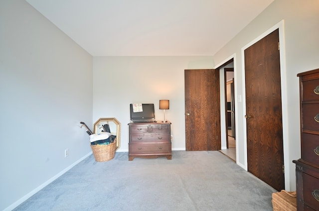 bedroom with a closet and light colored carpet