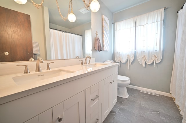 bathroom featuring toilet and vanity