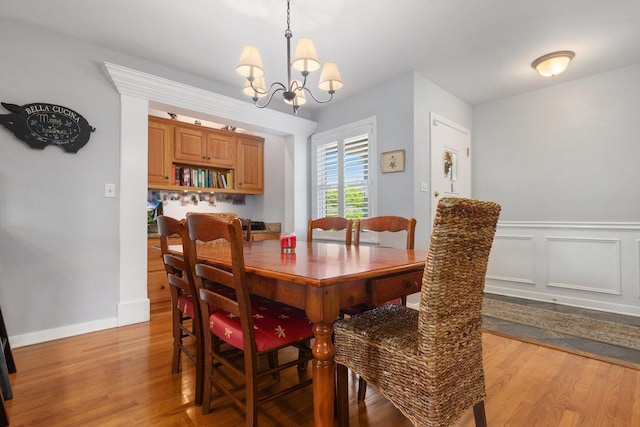 dining room featuring an inviting chandelier and light hardwood / wood-style floors