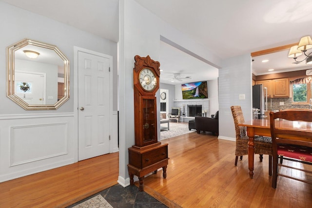 dining space with ceiling fan with notable chandelier