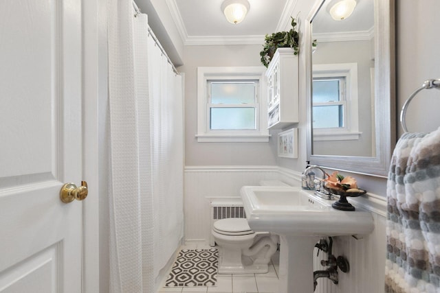 bathroom with toilet, tile patterned flooring, radiator heating unit, and crown molding