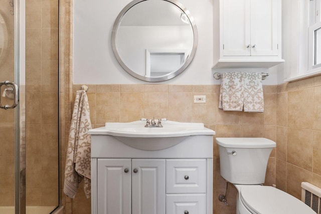 bathroom with tile walls, walk in shower, vanity, and toilet