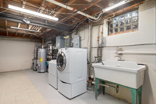 washroom with washer and dryer, sink, gas water heater, and electric panel