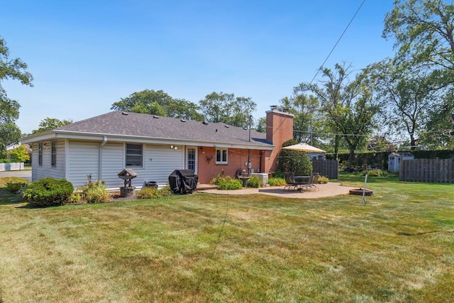 rear view of property featuring a patio and a yard