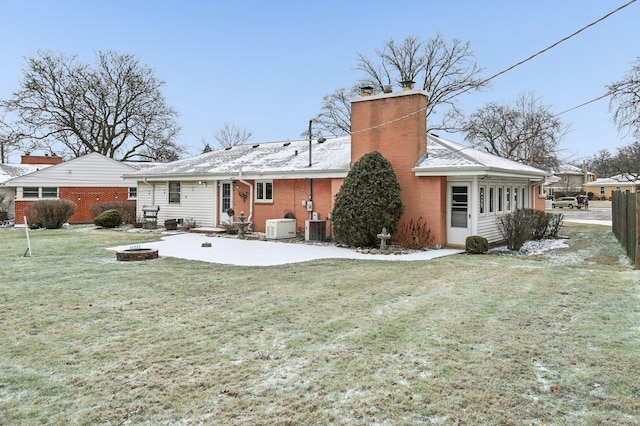 back of property featuring a yard, cooling unit, an outdoor fire pit, and a patio area