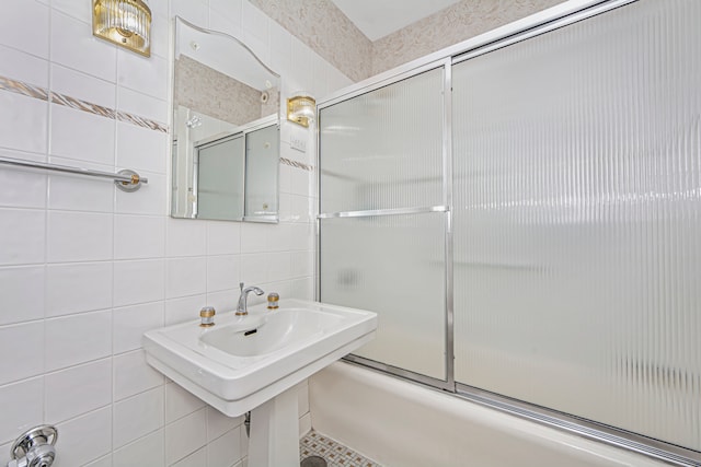 bathroom featuring enclosed tub / shower combo and tile walls