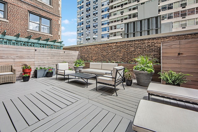 wooden terrace featuring an outdoor living space