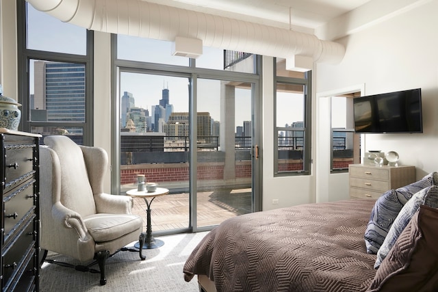 bedroom featuring beamed ceiling and access to outside