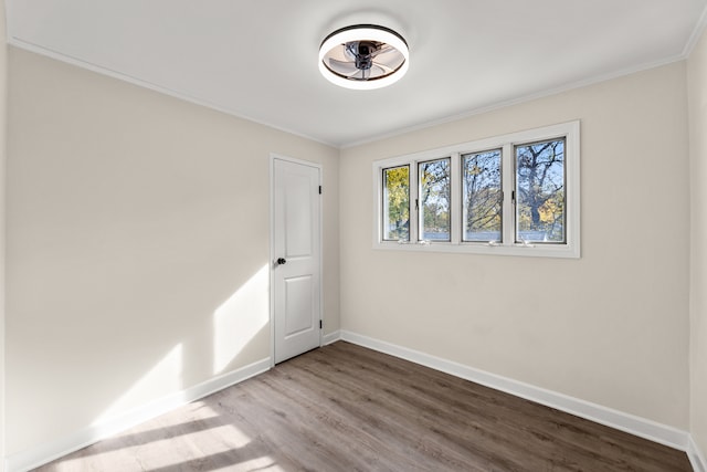 spare room with crown molding and hardwood / wood-style flooring