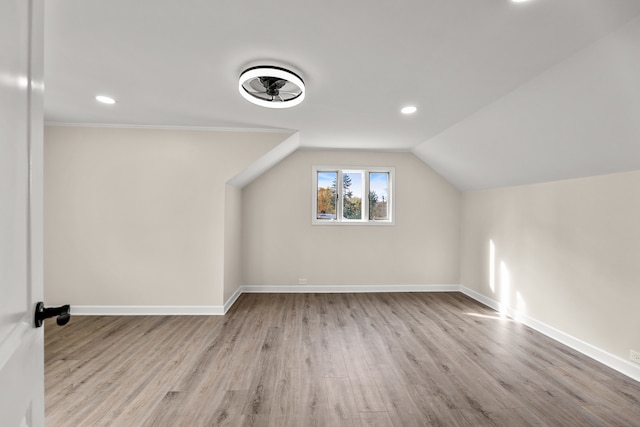 additional living space with lofted ceiling and light hardwood / wood-style flooring