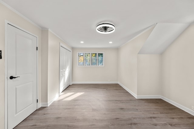 additional living space with light hardwood / wood-style flooring