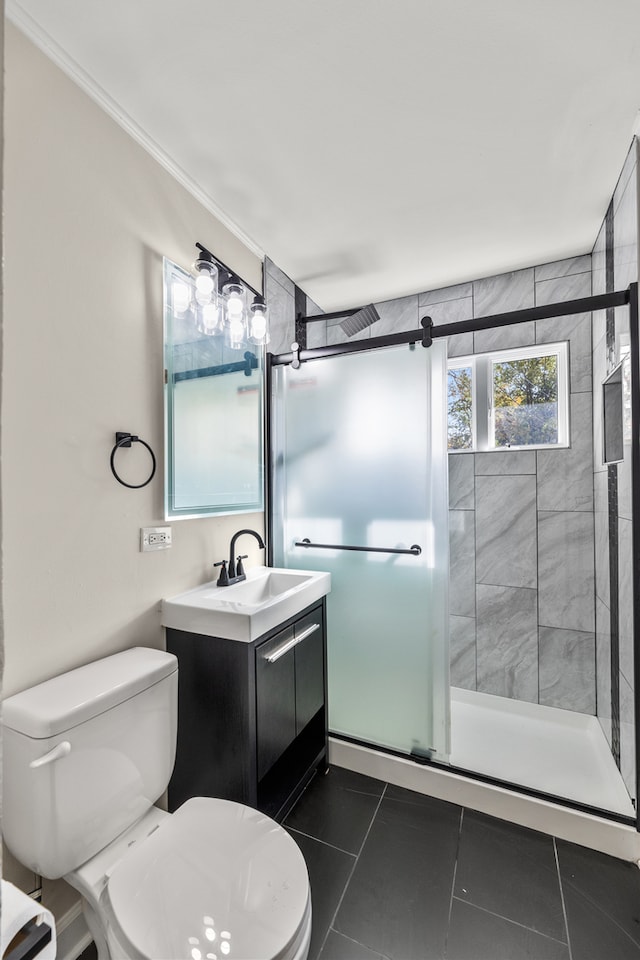 bathroom featuring vanity, toilet, tile patterned floors, and an enclosed shower