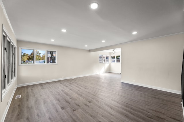 unfurnished room featuring ornamental molding and hardwood / wood-style flooring