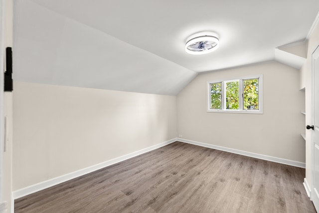 bonus room featuring light hardwood / wood-style floors and vaulted ceiling