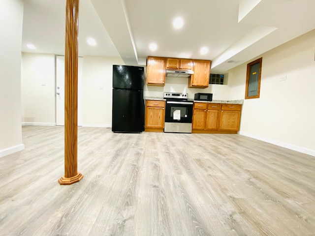 kitchen with stainless steel range with electric stovetop, decorative columns, light wood-type flooring, and black fridge