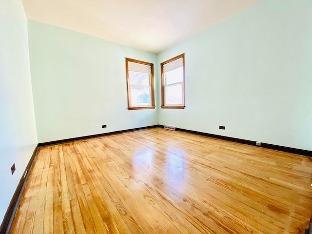 empty room with light hardwood / wood-style flooring