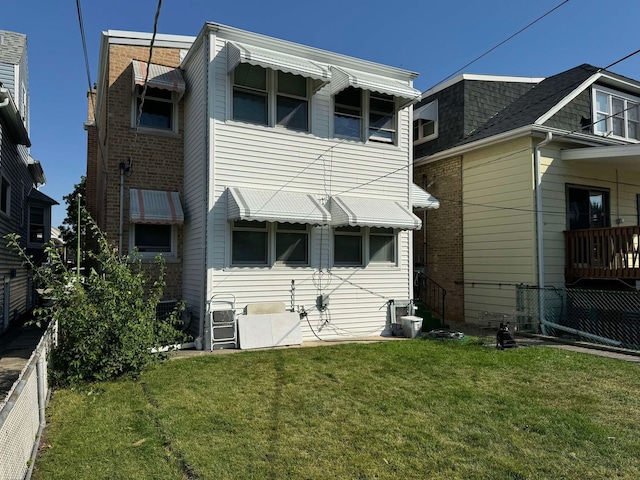 rear view of house with a yard