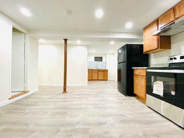 kitchen featuring decorative backsplash, electric range, light hardwood / wood-style flooring, and black fridge