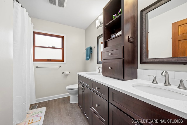 bathroom featuring vanity, toilet, and wood-type flooring