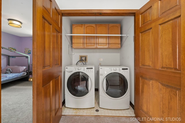 laundry area featuring light carpet, cabinets, and washer and dryer