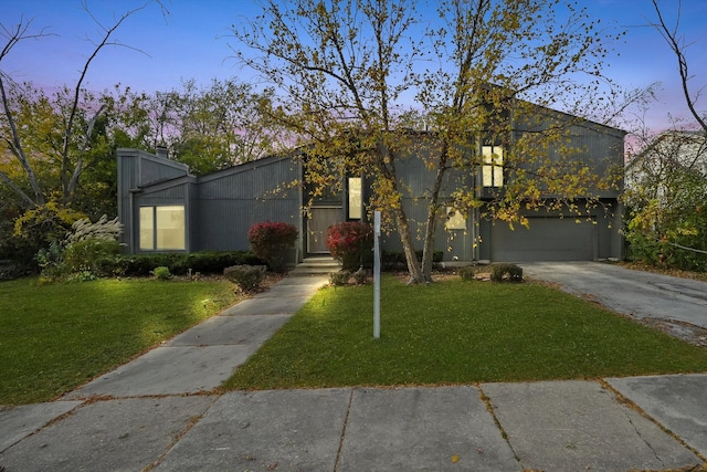 view of front of home with a yard and a garage