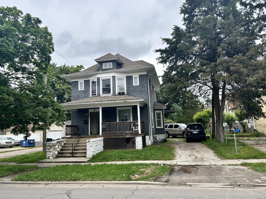 653 E River St, Kankakee, IL 60901 - traditional style home with covered porch, driveway, and a garage